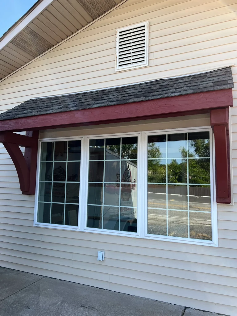 Painted house with windows and awning
